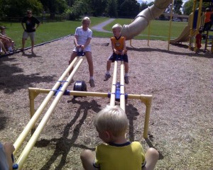 My kids trying to balance on see saws at the playground