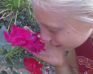 Anna smelling a flower