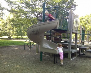 Jake at the top of the slide and Tricia getting off at the bottom