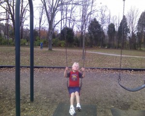 Jake swinging at the park