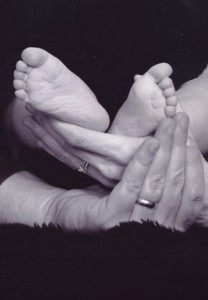Me and my husband holding Jake's tiny feet 9 years ago
