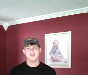 His first day of work, his 1 year old picture behind him