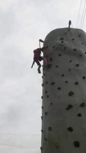Spencer climbing a rock wall